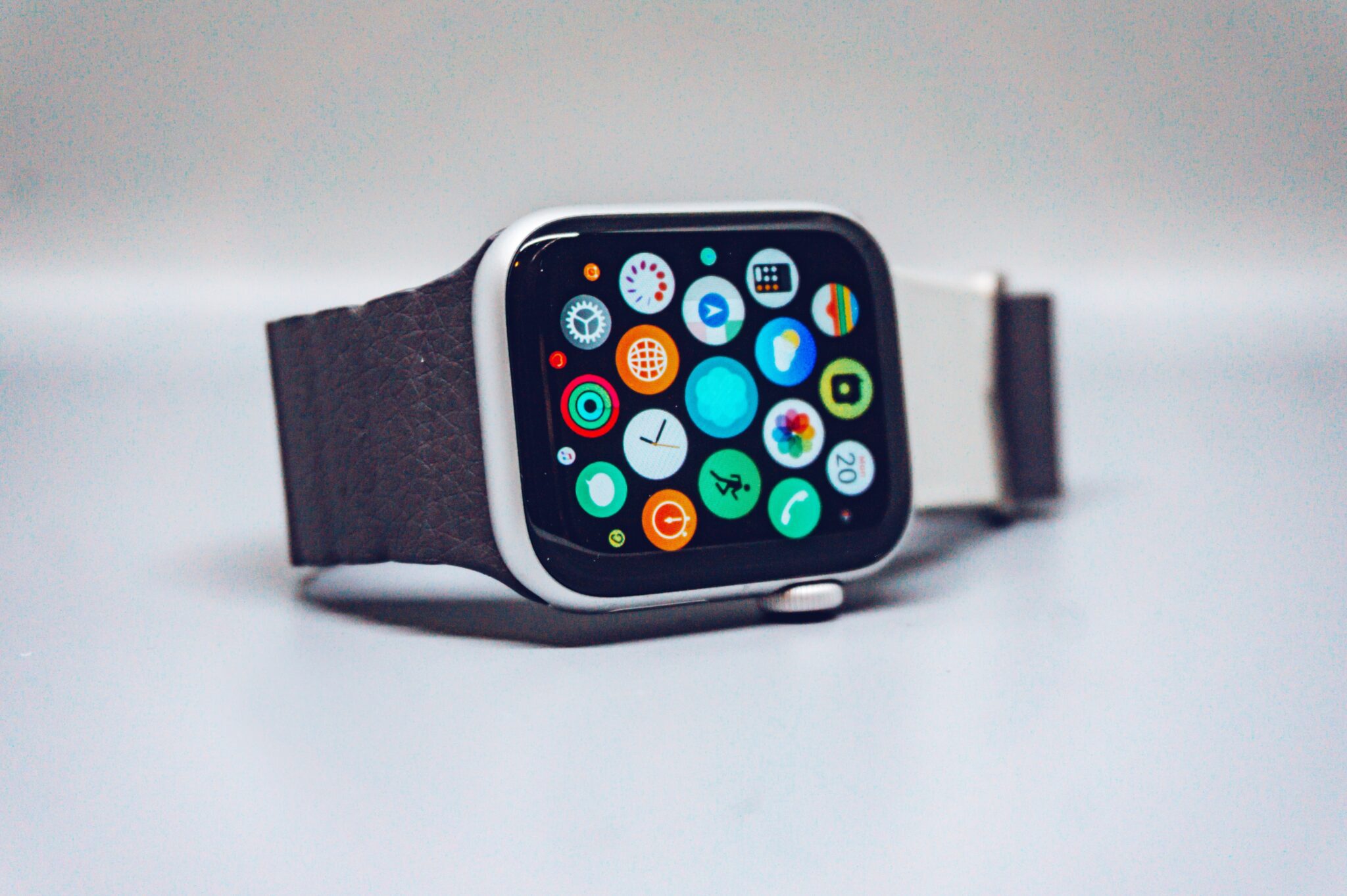 Smart watch with lit-up display featuring various apps